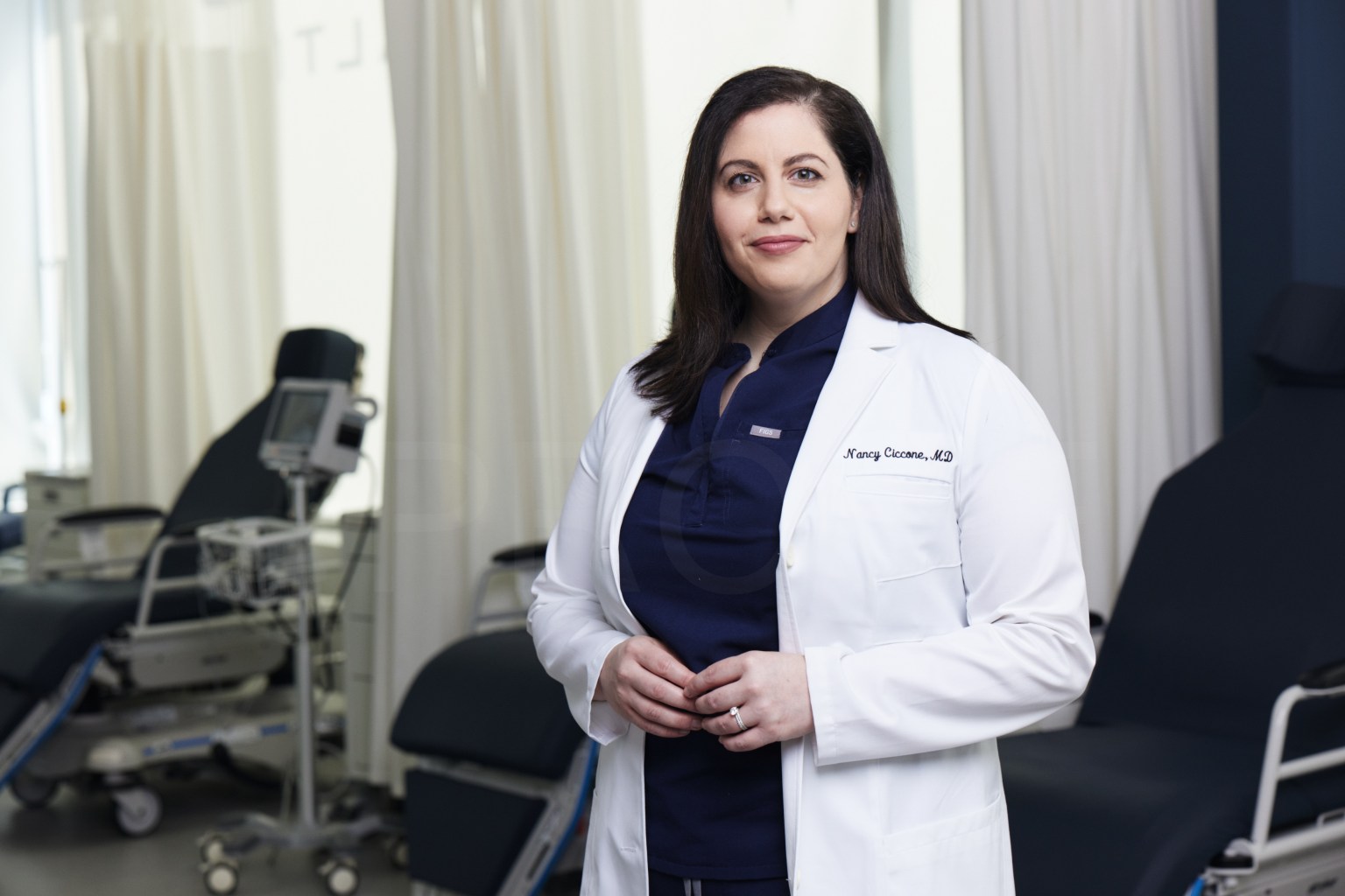 A Doctor in a White Coat Standing in Medical Room.