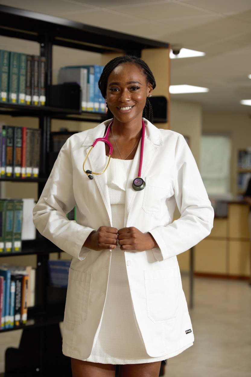 Woman in a White Lab Coat Standing in MUA Library